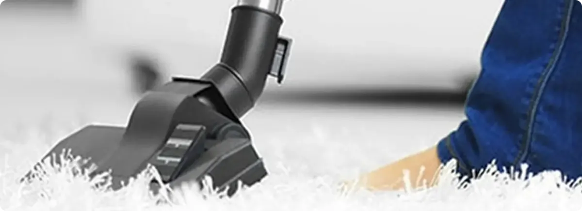 Close-up of a professional vacuuming a white carpet in Mesa.